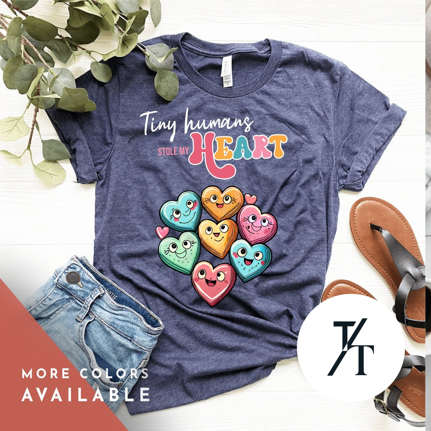 a shirt that says "tiny humans stole my heart"with a collage of candy hearts with cute faces on them