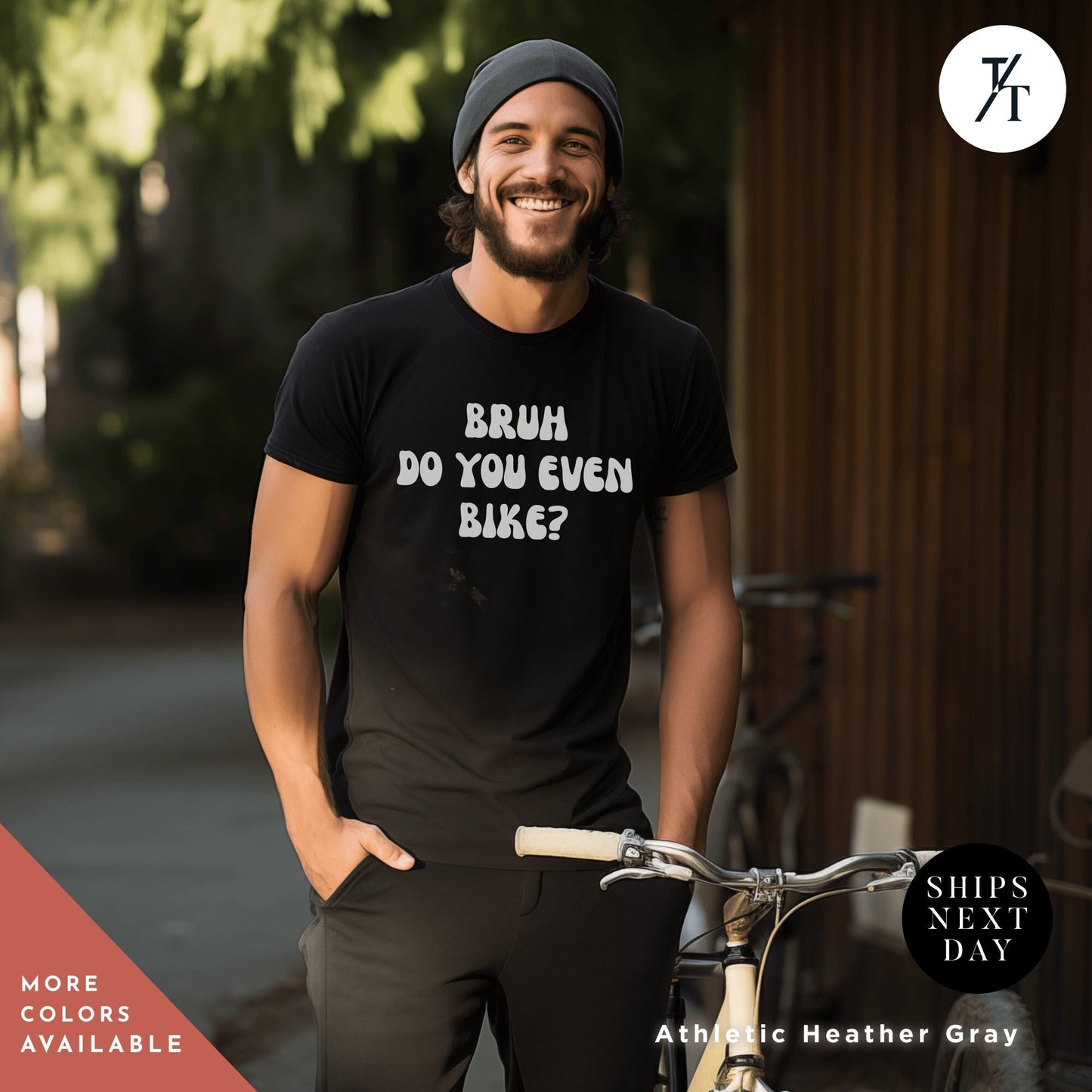 a man standing next to a bike wearing a t - shirt
