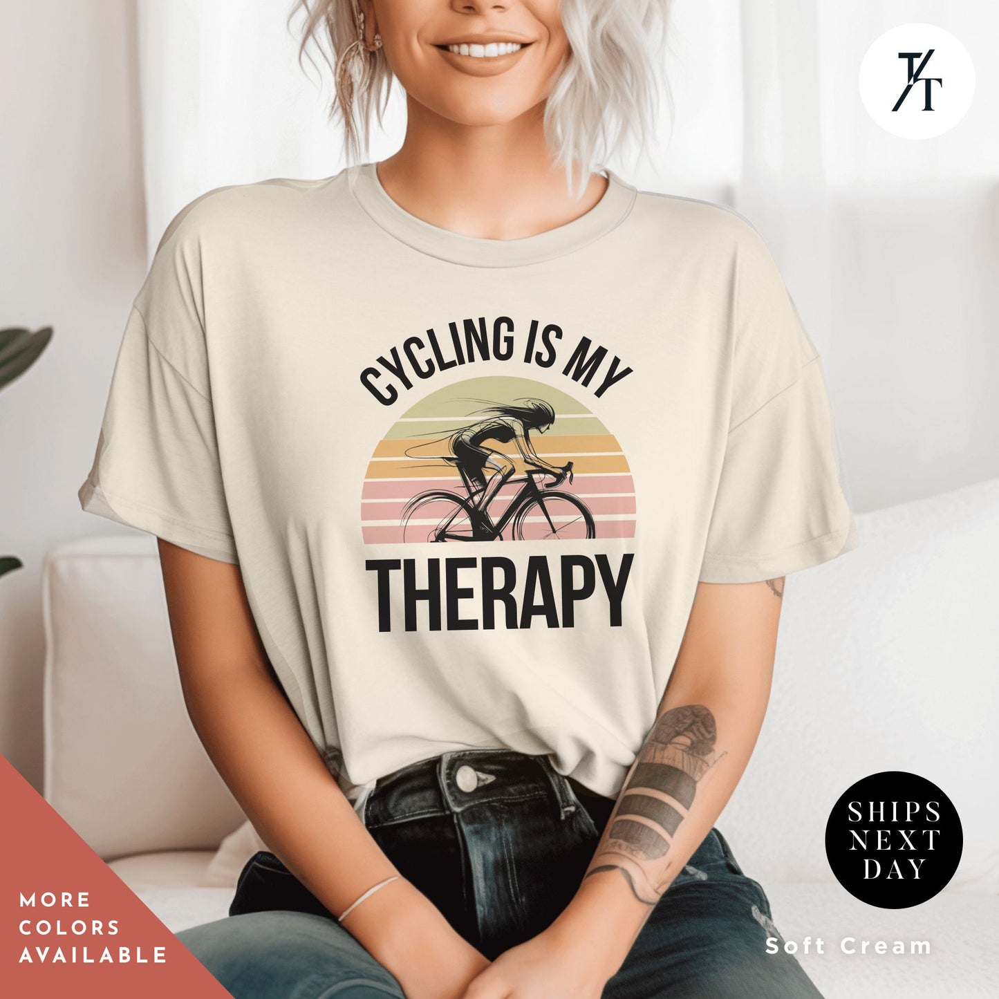 a woman sitting on a couch wearing a shirt that says cycling is my therapy