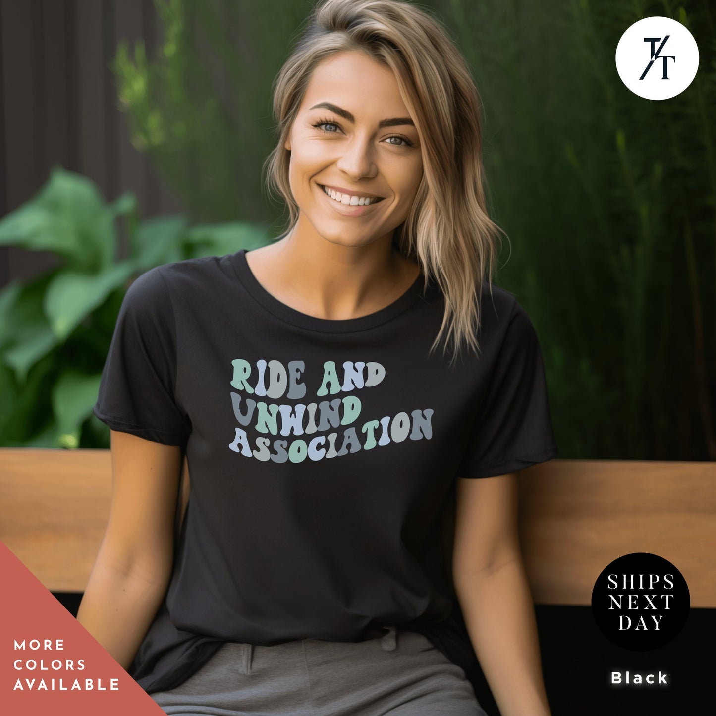 a woman sitting on a bench wearing a black shirt