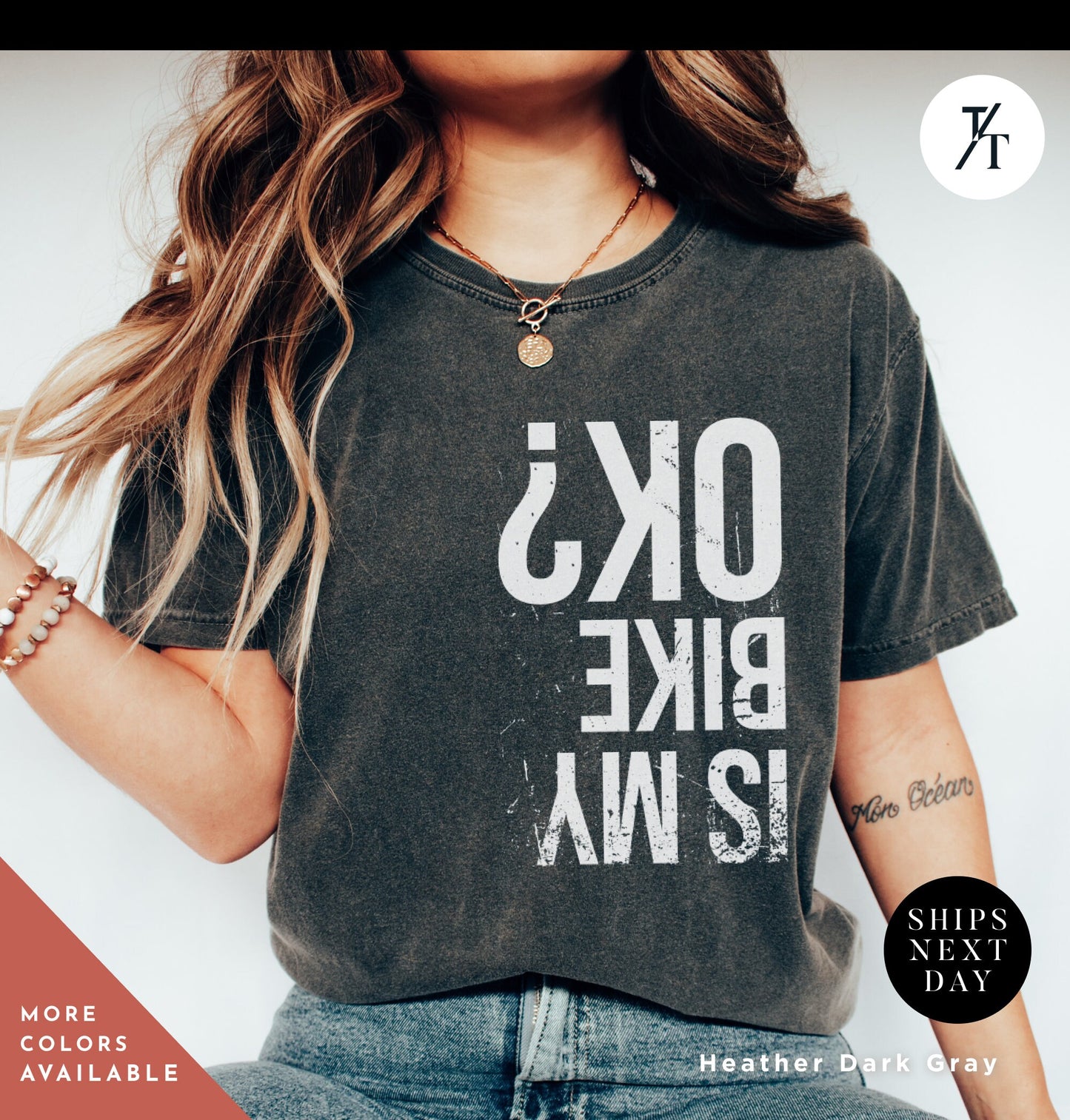 a woman with long hair wearing a shirt that says ok's bike 12 /
