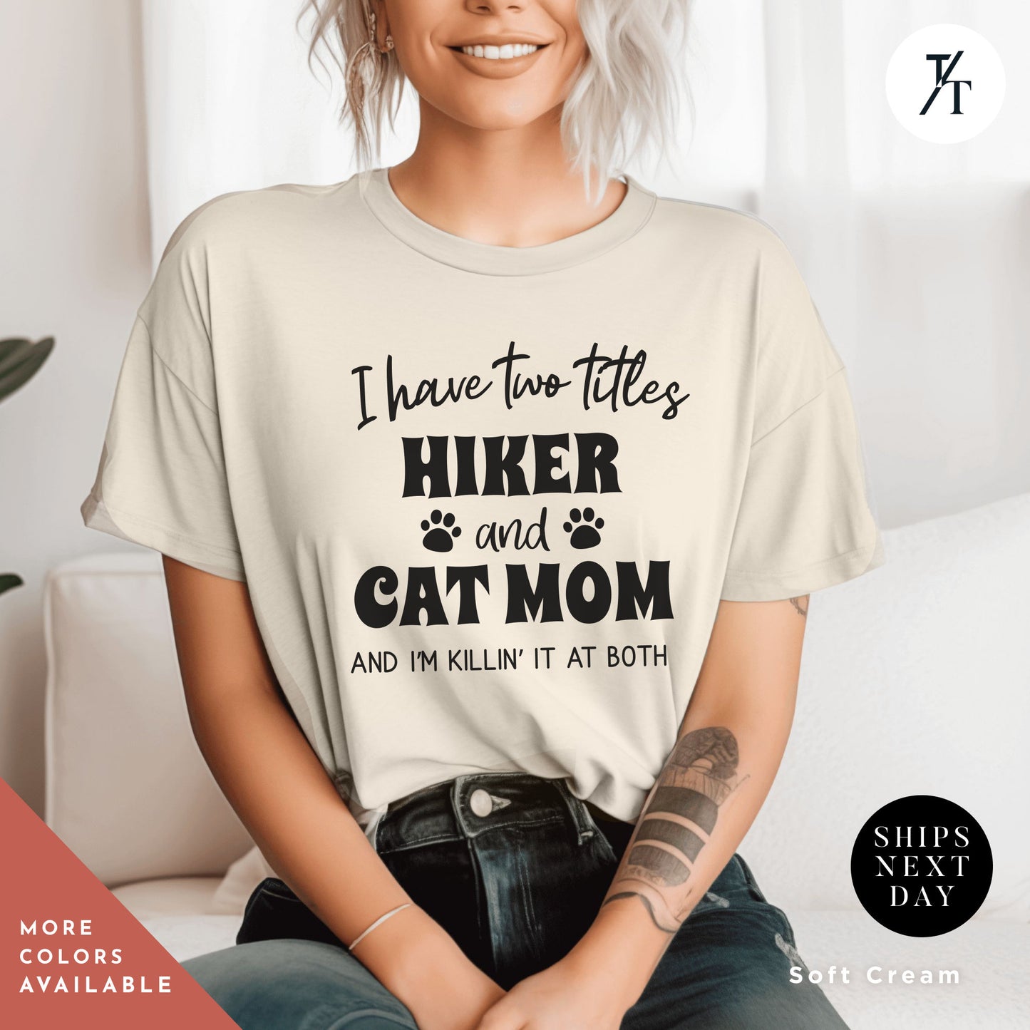 a woman sitting on a couch wearing a t - shirt that says i have two