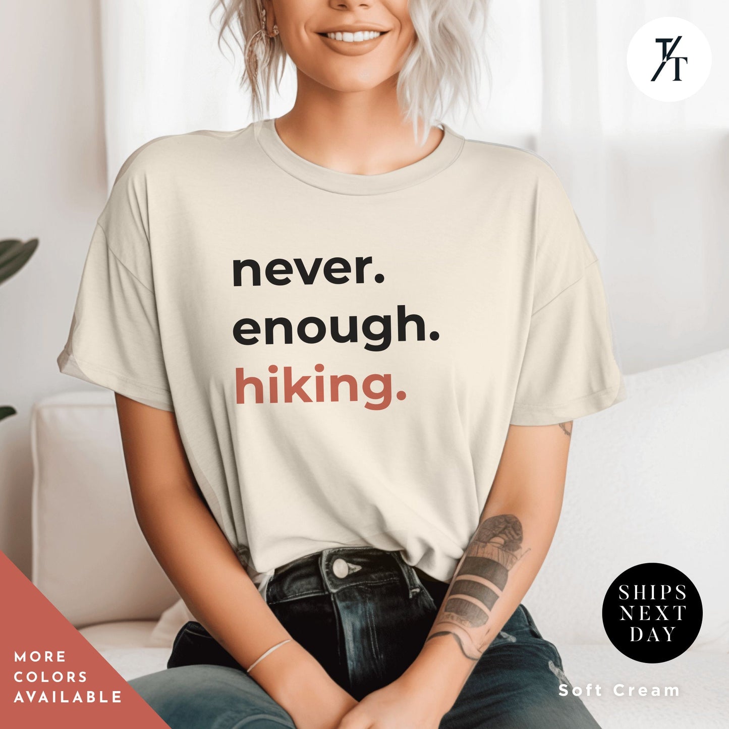 a woman sitting on a couch wearing a t - shirt that says never enough hiking