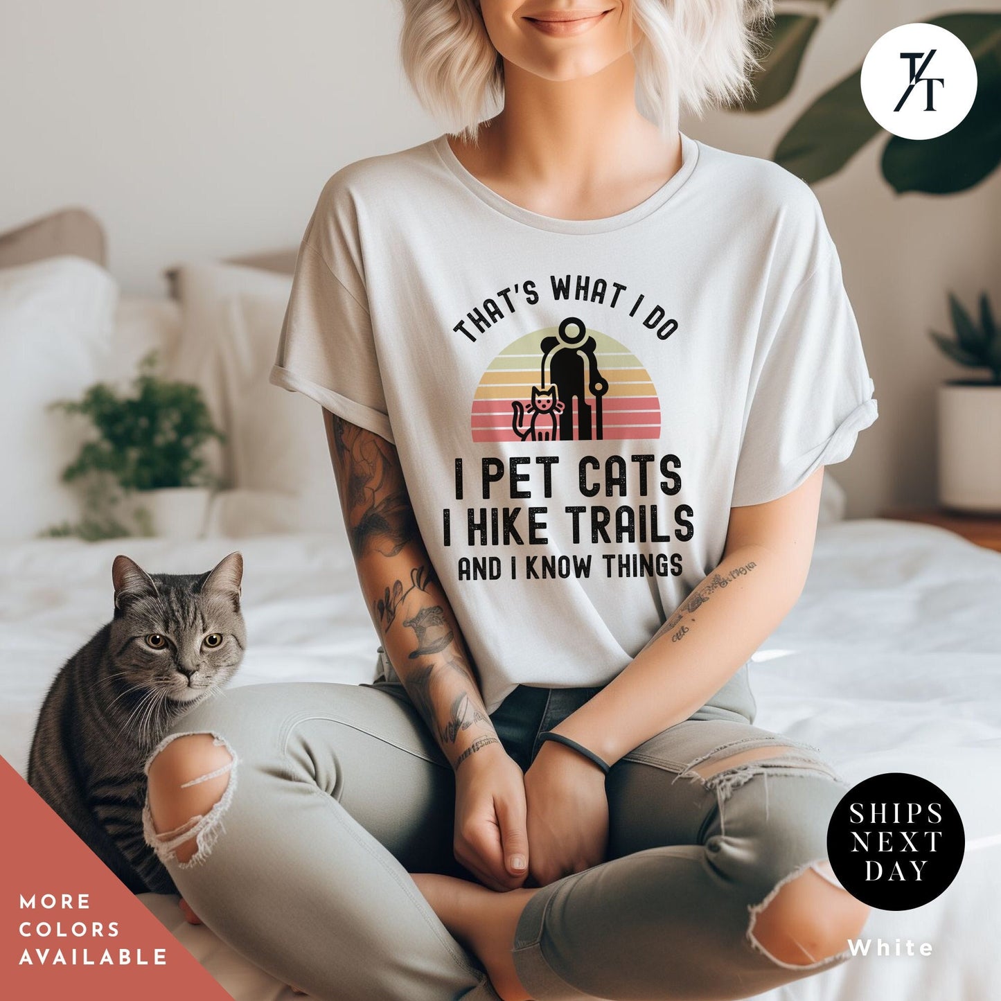 a woman sitting on top of a bed next to a cat