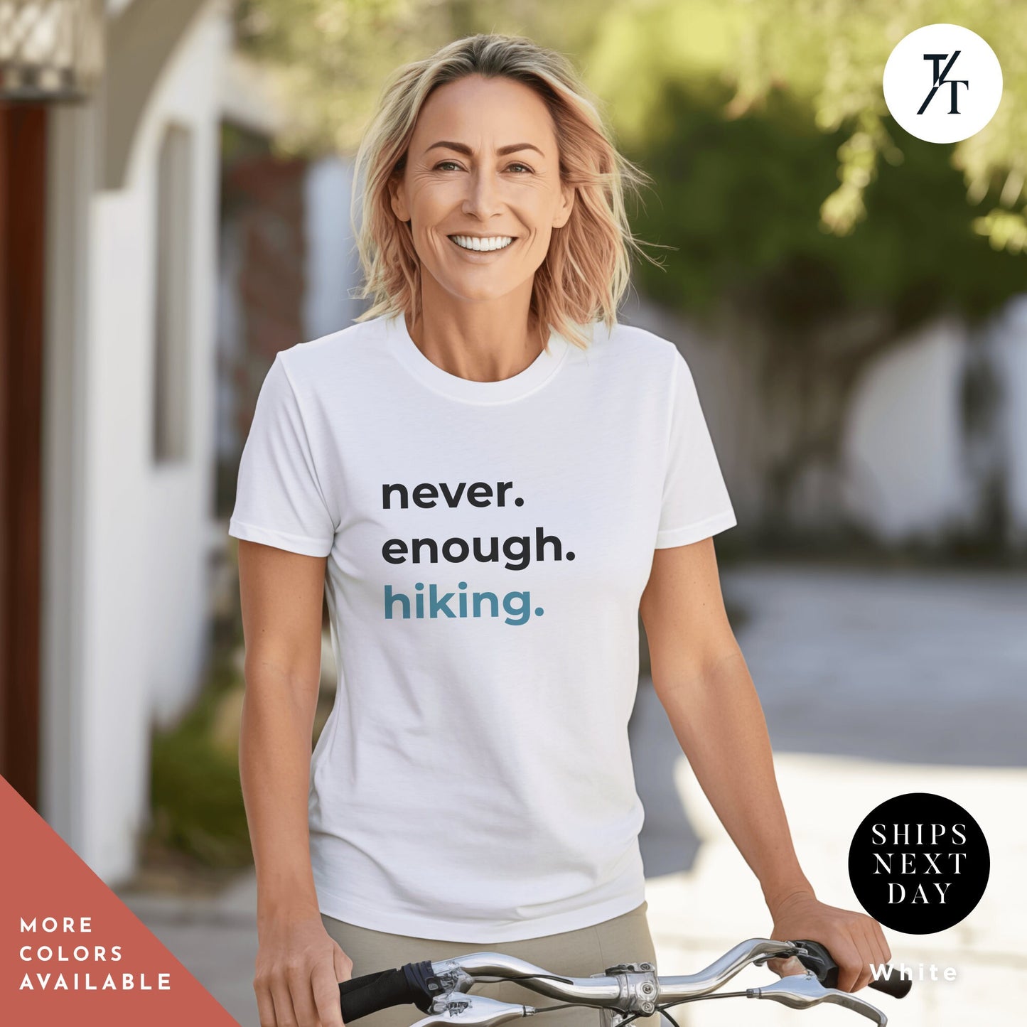a woman riding a bike wearing a t - shirt that says never enough hiking