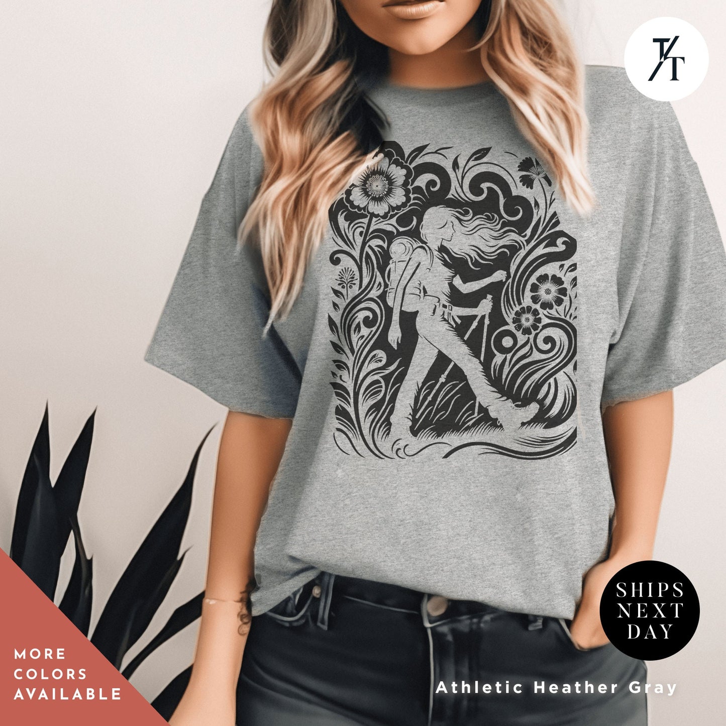a woman wearing a t - shirt with a graphic of a mermaid