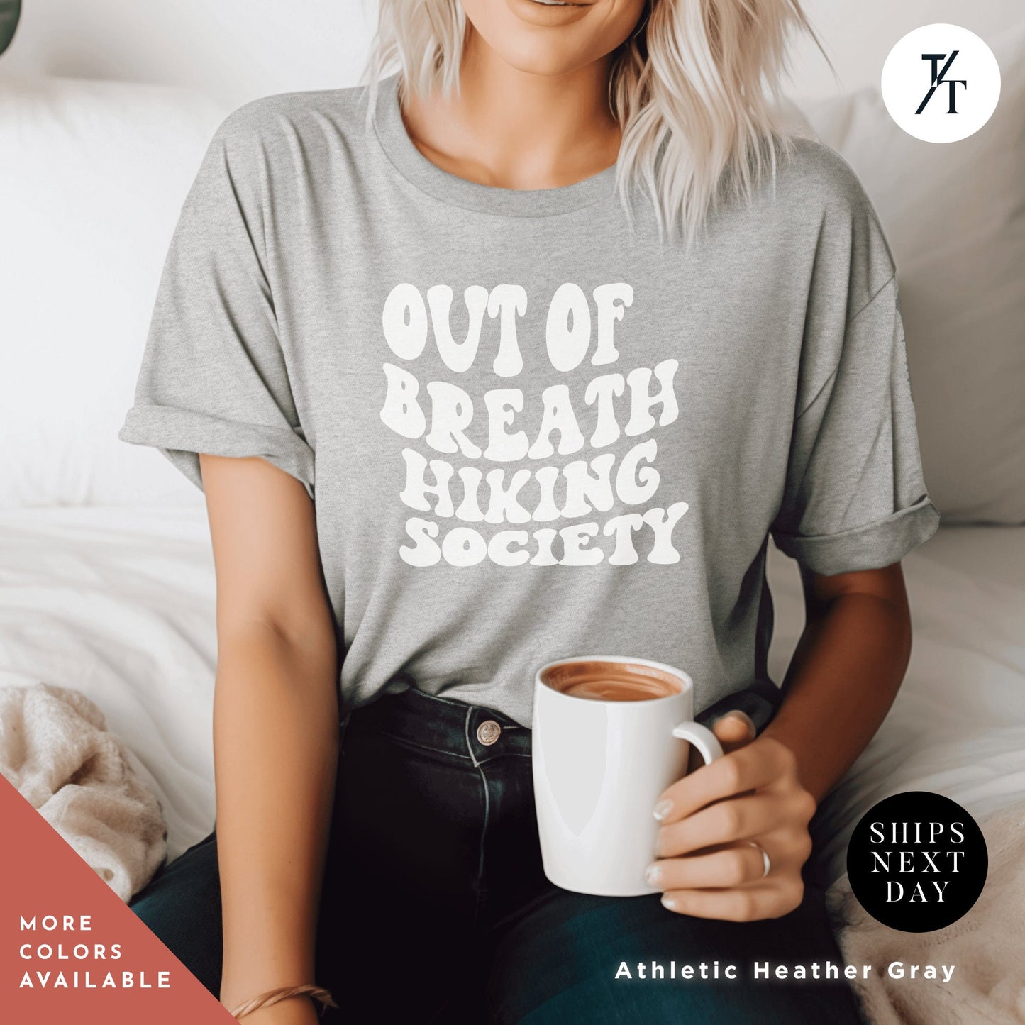 a woman sitting on a bed holding a cup of coffee