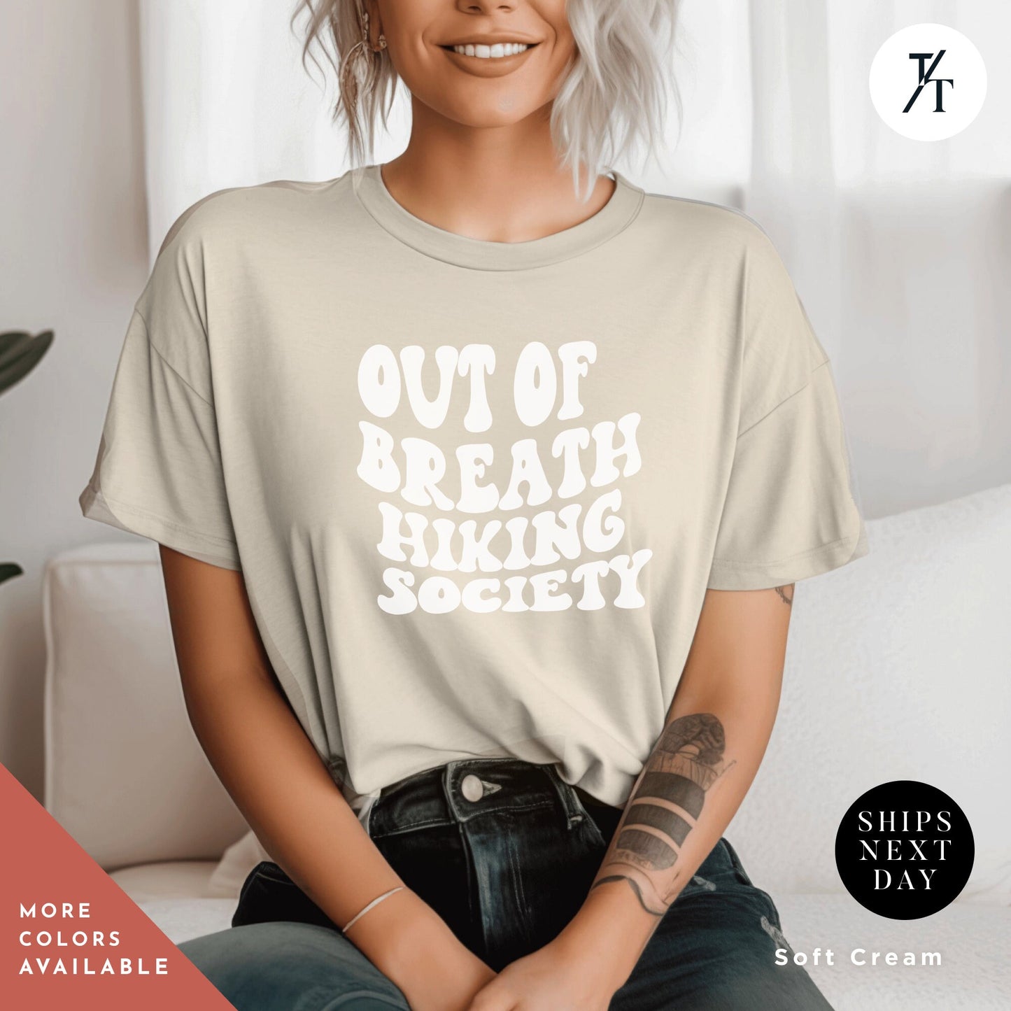 a woman sitting on a couch wearing a t - shirt that says out of breath