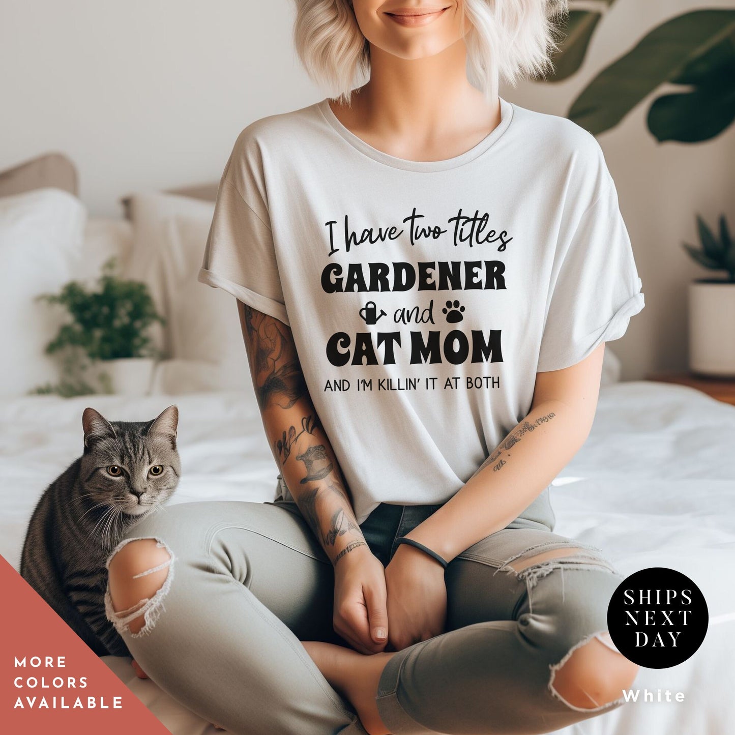 a woman sitting on a bed with a cat and a shirt that says a t - shirt that says i have two titles gardener and cat mom and i am rockin' them both