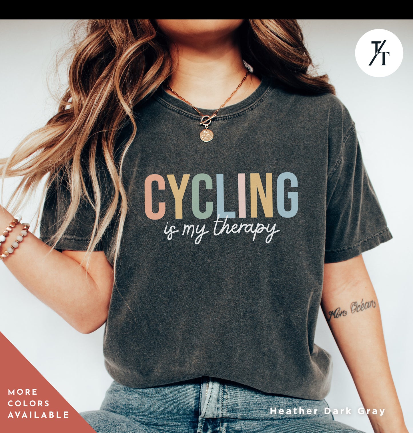 a woman wearing a t - shirt that says cycling is my therapy
