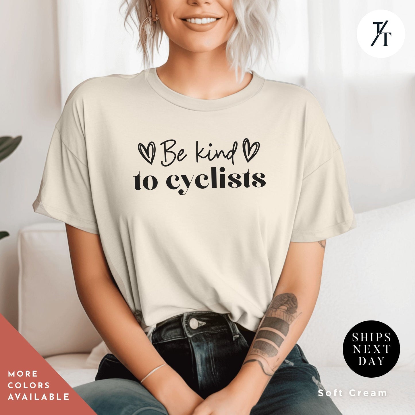 a woman sitting on a couch wearing a t - shirt that says be kind of