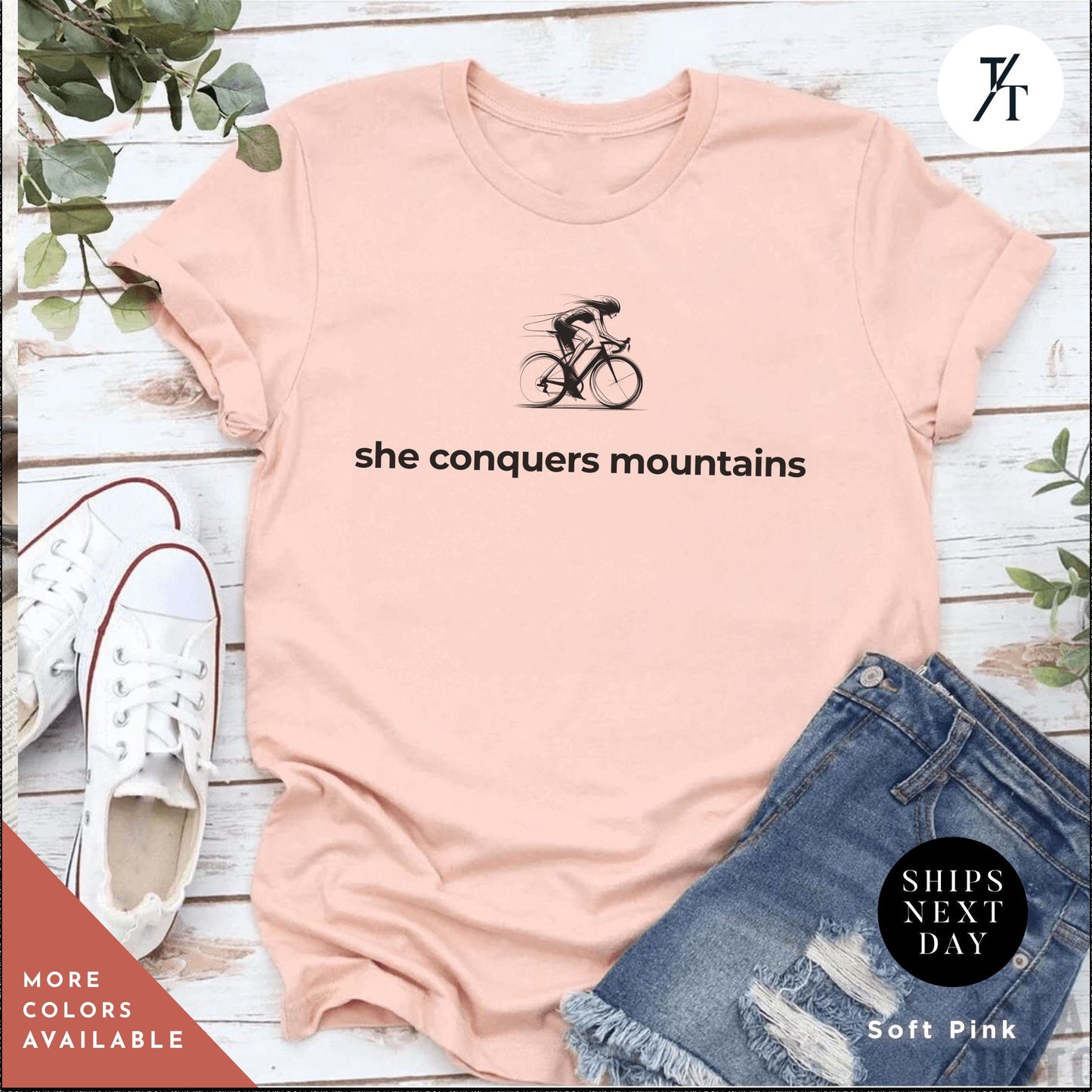 a pink shirt with the words she conquers mountains on it