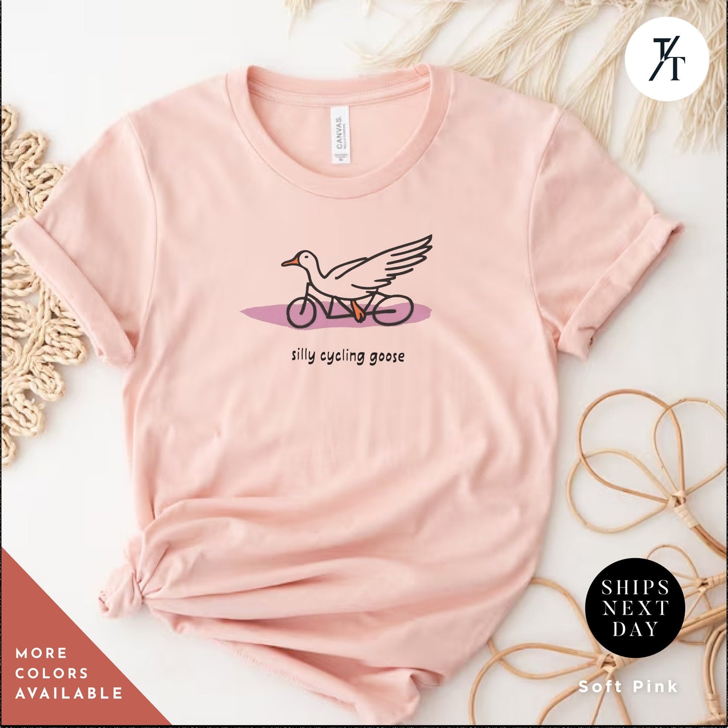 a pink shirt with a bird on it