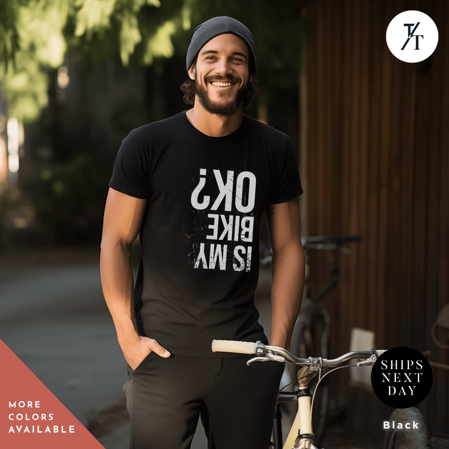 a man standing next to a bike wearing a black shirt