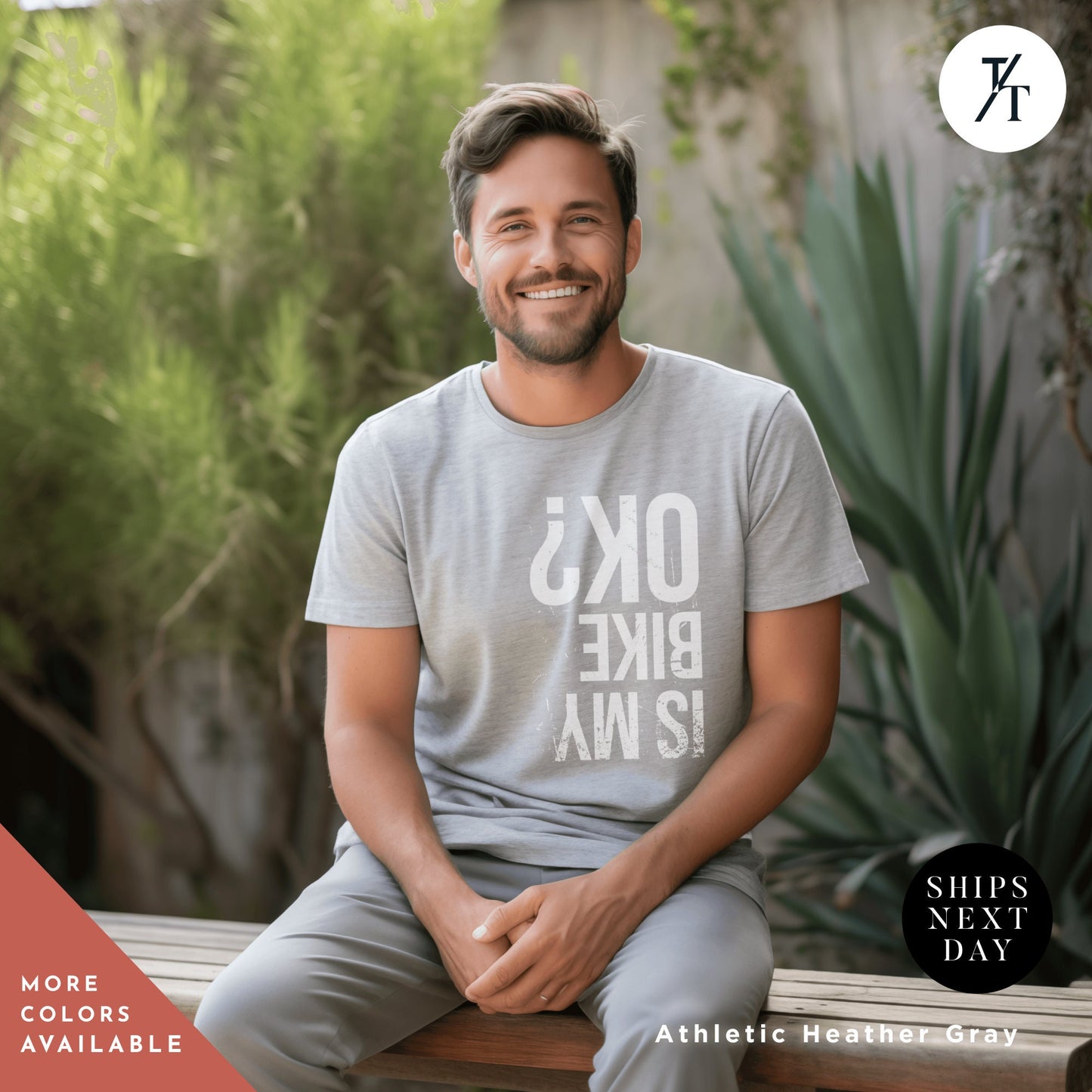 a man sitting on a bench wearing a t - shirt