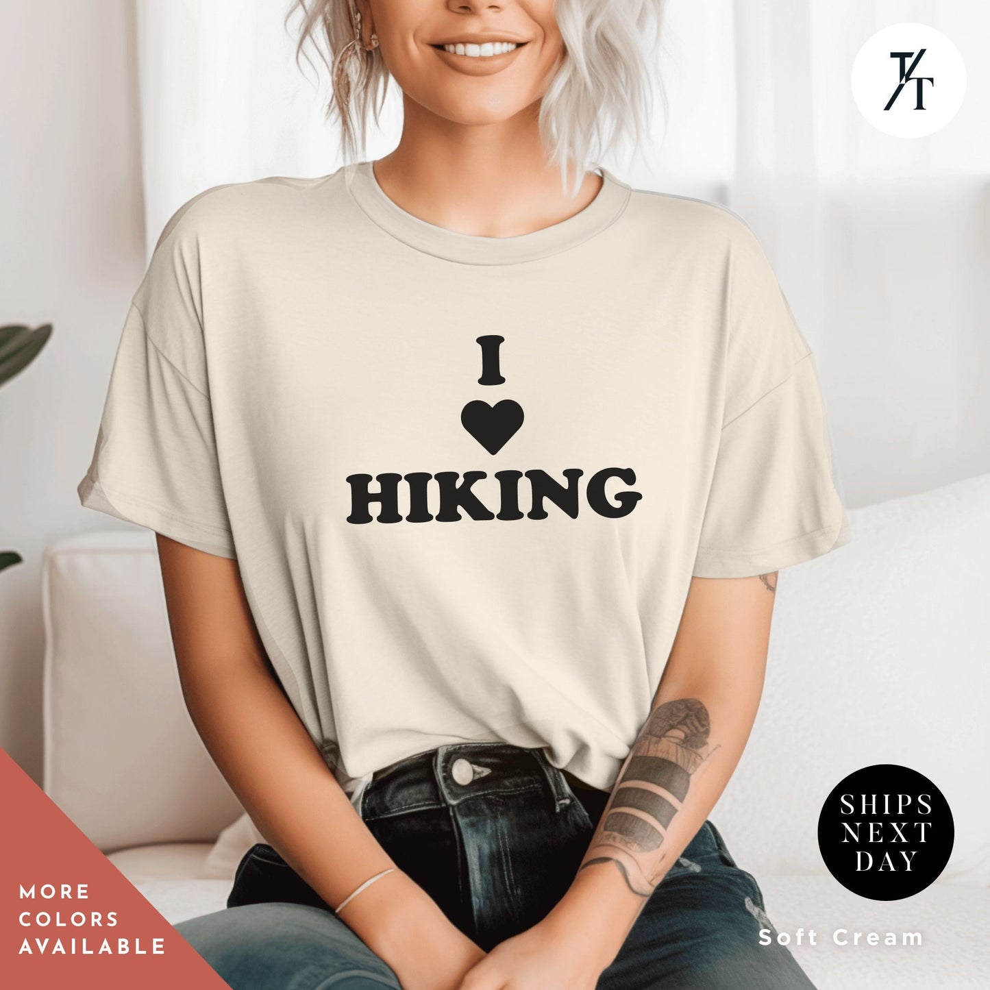 a woman sitting on a couch wearing a shirt that says i love hiking