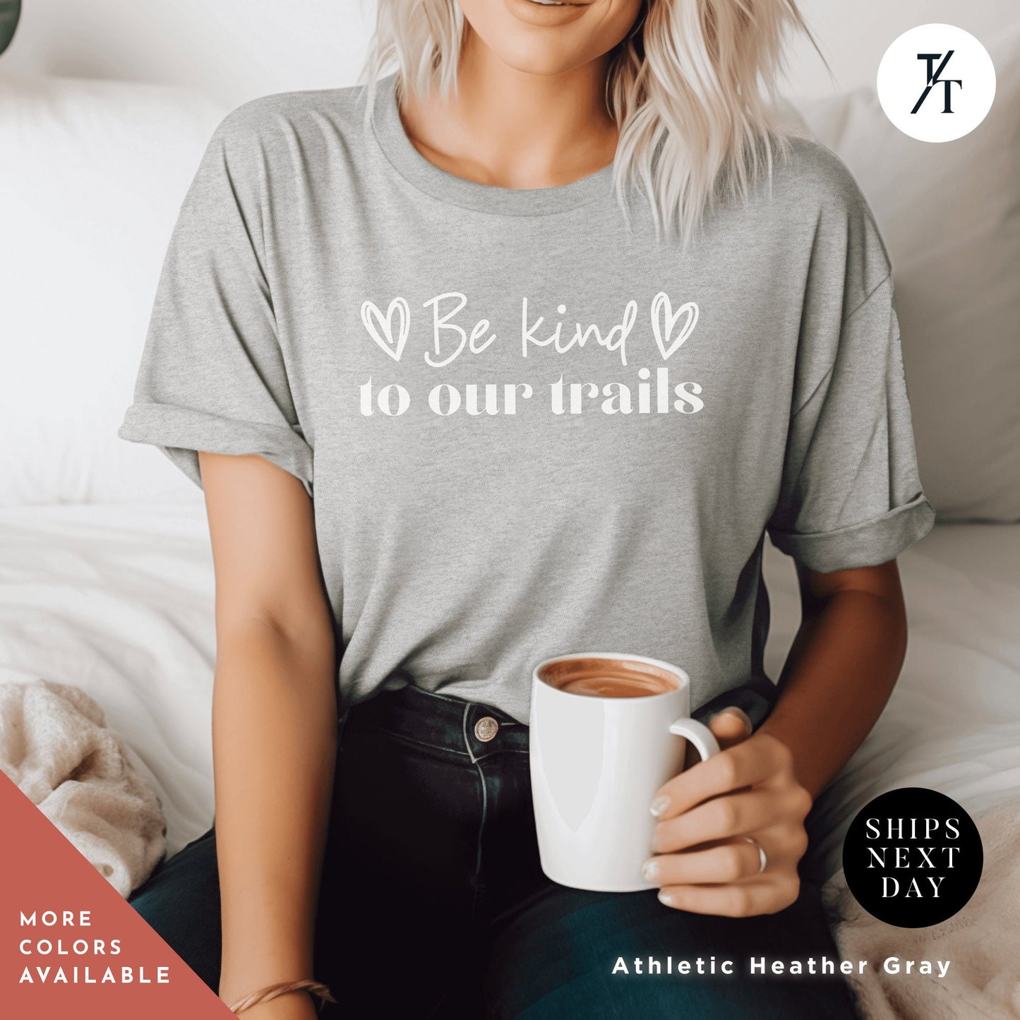 a woman sitting on a bed holding a cup of coffee