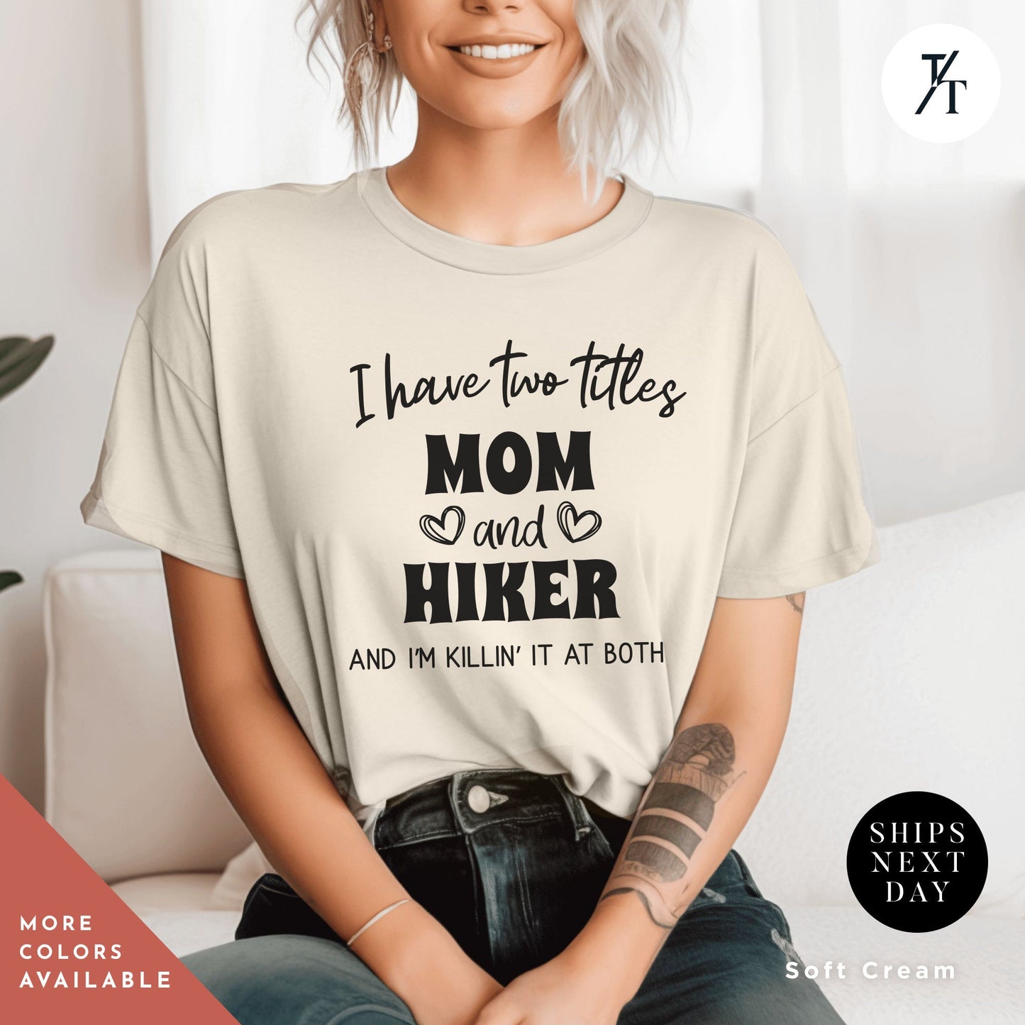 a woman sitting on a couch wearing a t - shirt that says i have two