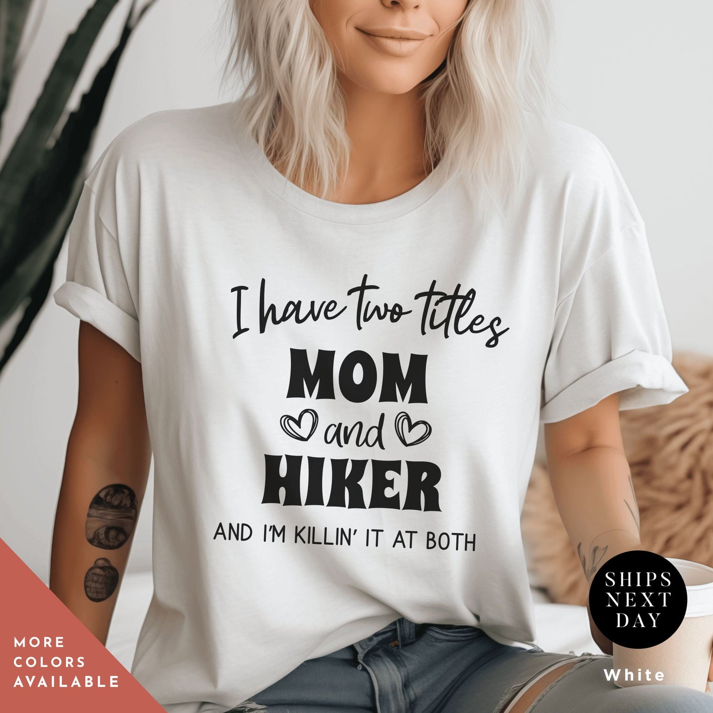 a woman wearing a t - shirt that says i have two titles mom and hike