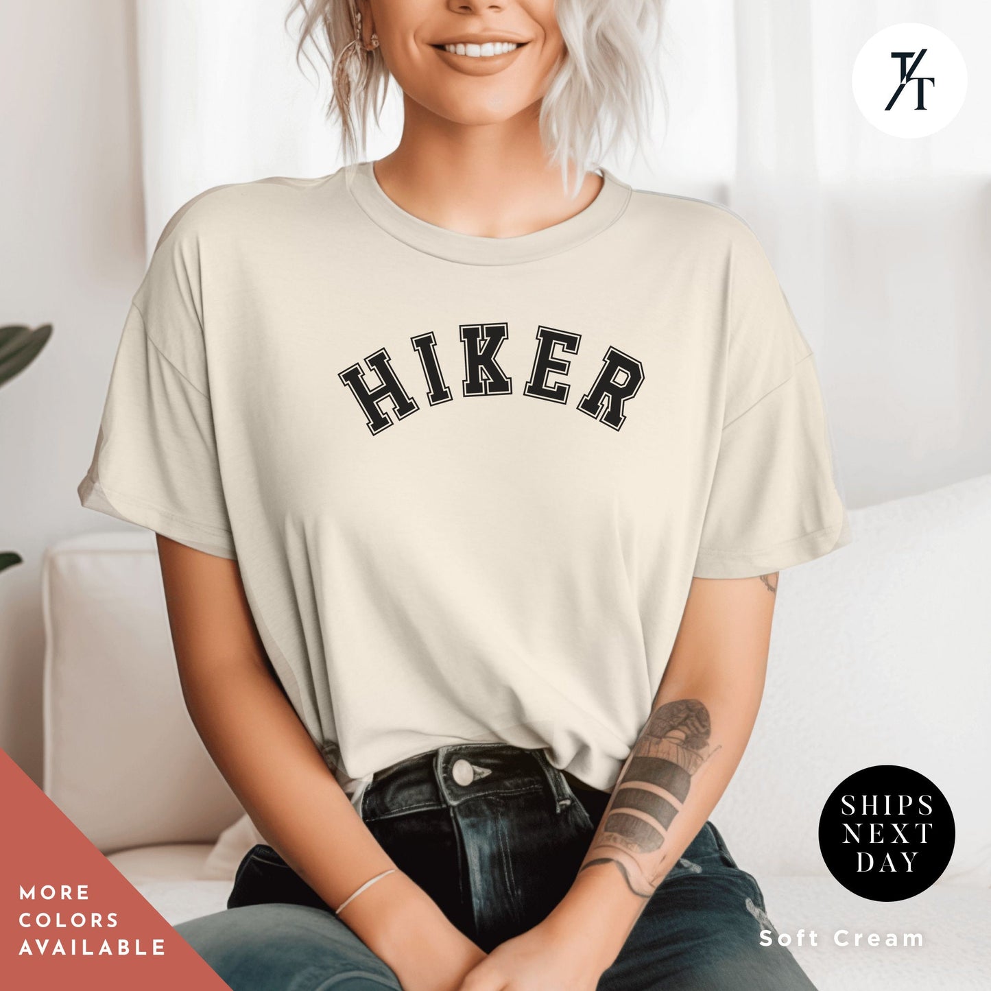 a woman sitting on a couch wearing a shirt that says hike