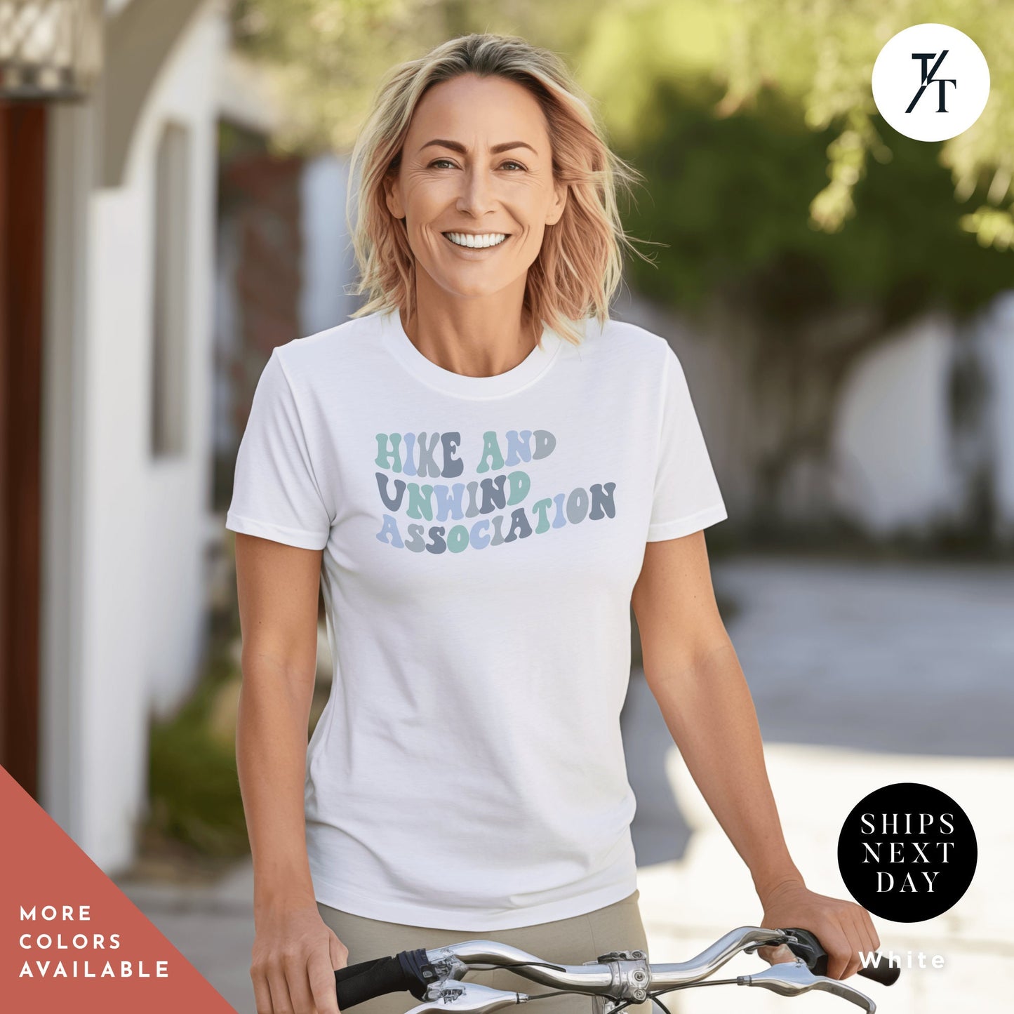 a woman riding a bike wearing a white shirt