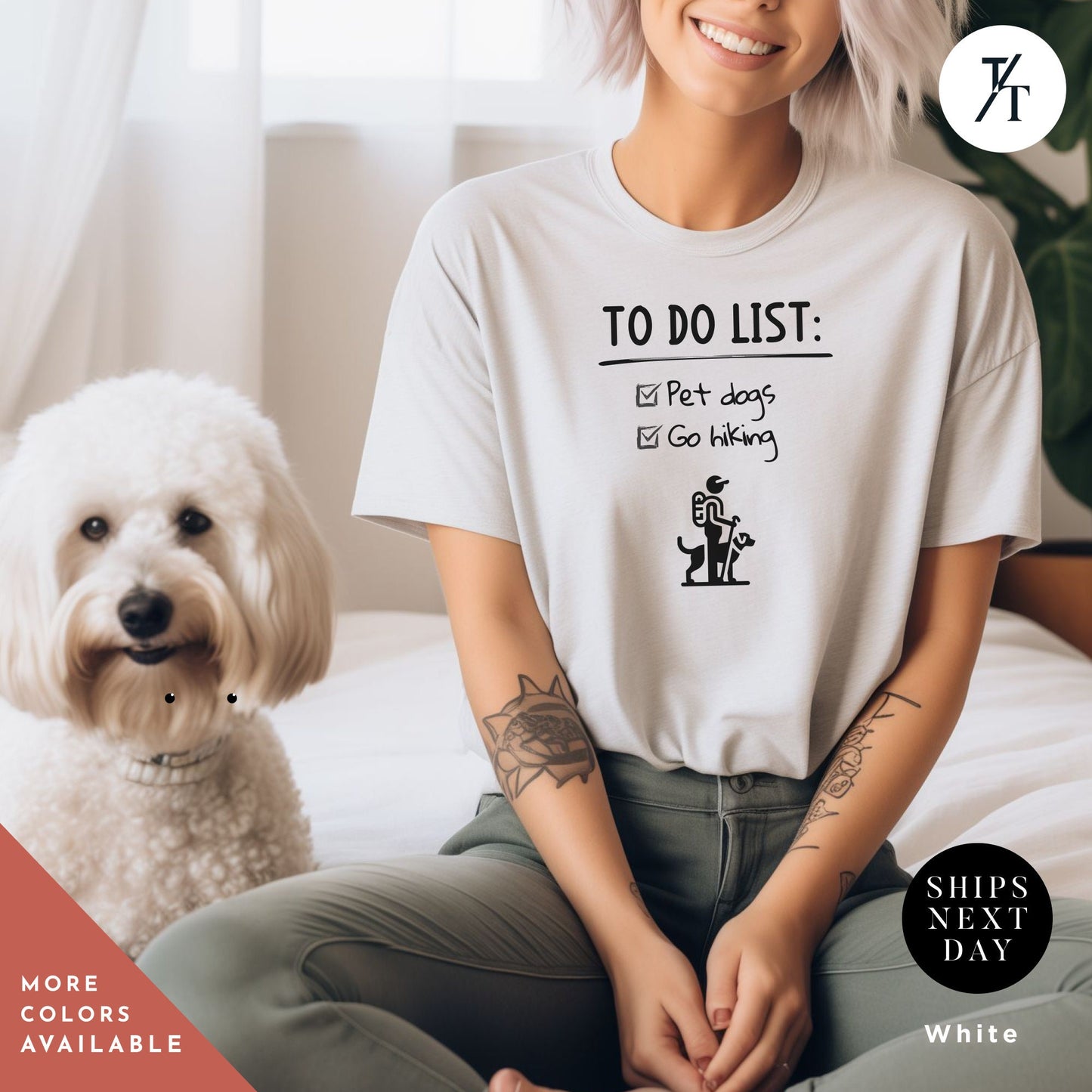 a woman sitting on a bed next to a white dog