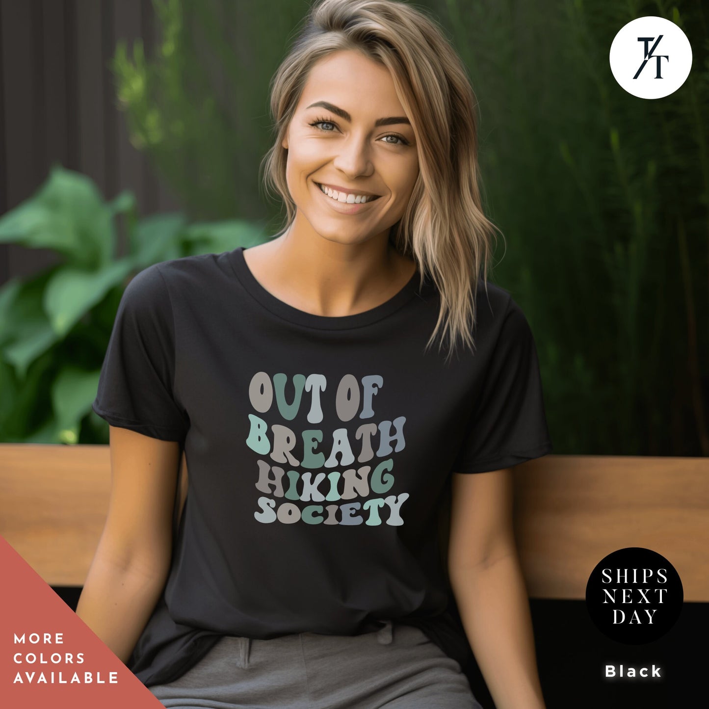 a woman sitting on a bench wearing a t - shirt that says out of breath