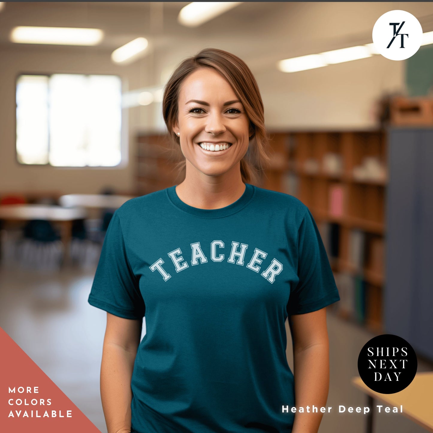 a smiling woman wearing a teacher shirt in a library