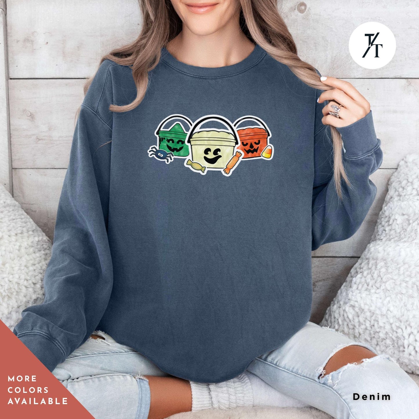 a woman sitting on a couch wearing a sweatshirt