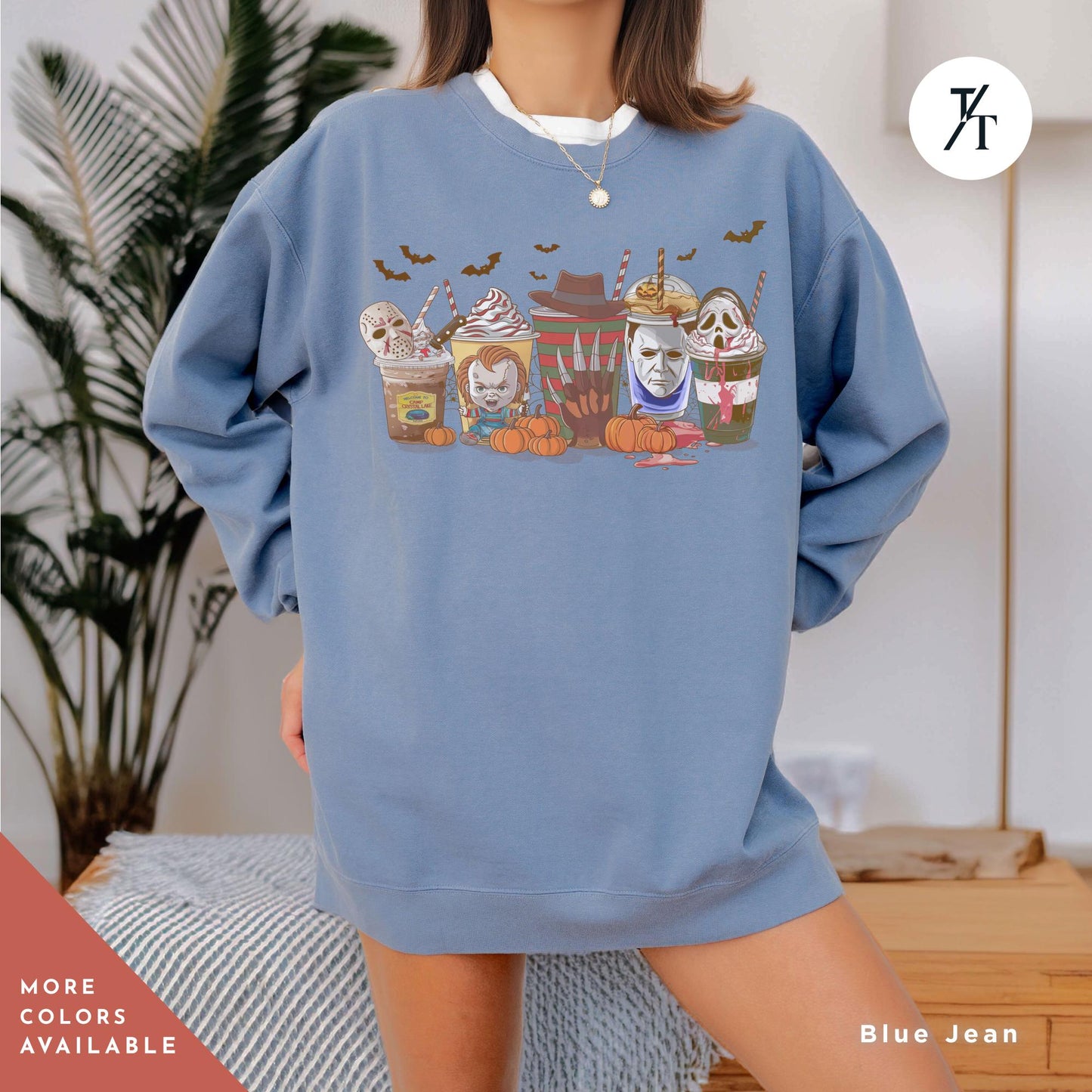 a woman wearing a blue sweatshirt with a picture of a group of cats on it