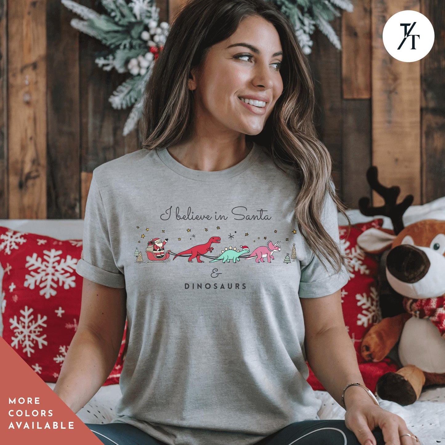 a woman sitting on a bed with a stuffed animal, I believe in santa and dinosaurs shirt, Santa And Dinosaurs, Christmas Dinosaur, Cute Christmas Shirt, Dinosaur Sweatshirt, Funny Xmas Shirt