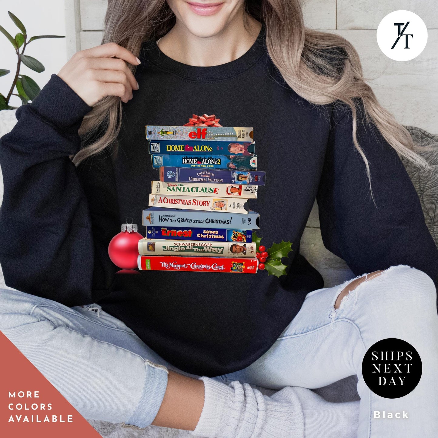 a woman sitting on a couch holding a stack of VHS tapes on it, Vintage christmas vhs sweatshirt, Christmas Sweatshirt, Holiday Crewneck, Vhs Movies Sweater, Gift For Her, Retro Xmas Video Cassette Tapes