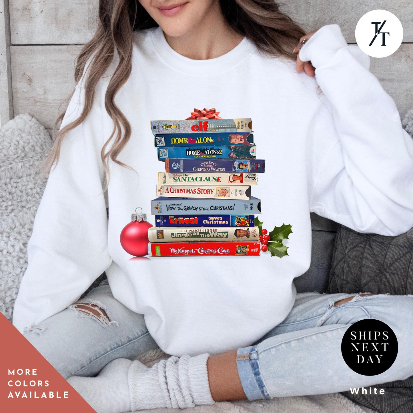 a woman wearing a white sweatshirt with a stack of VHS tapes on it, Vintage christmas vhs sweatshirt, Christmas Sweatshirt, Holiday Crewneck, Vhs Movies Sweater, Gift For Her, Retro Xmas Video Cassette Tapes