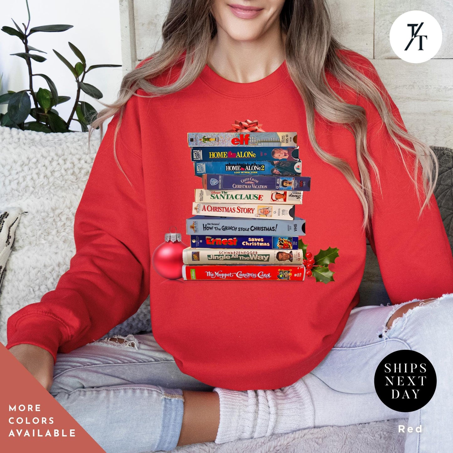 a woman wearing a red sweatshirt with a stack ofVHS tapes on it, Vintage christmas vhs sweatshirt, Christmas Sweatshirt, Holiday Crewneck, Vhs Movies Sweater, Gift For Her, Retro Xmas Video Cassette Tapes