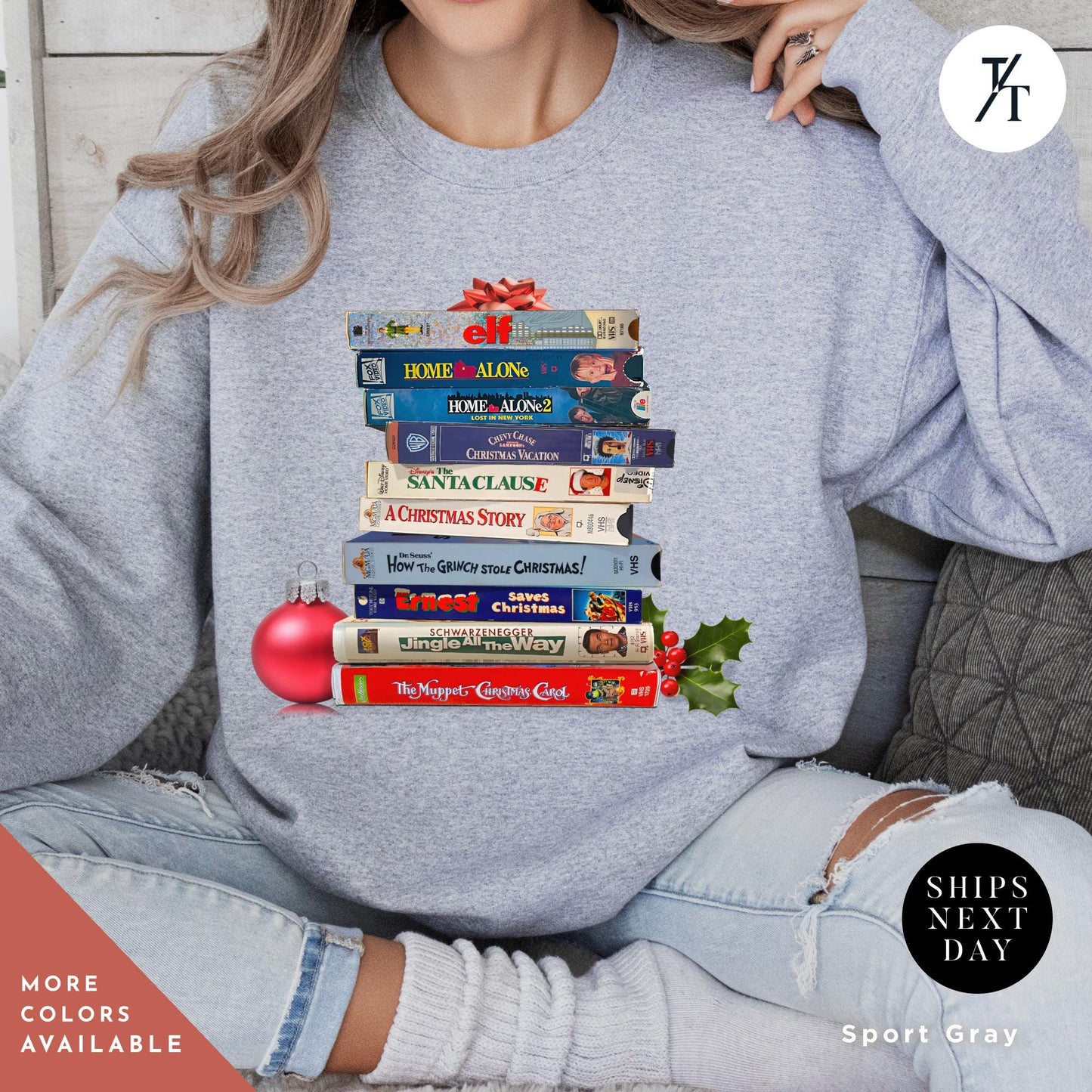 a woman wearing a sweatshirt with a stack of VHS tapes on it, Vintage christmas vhs sweatshirt, Christmas Sweatshirt, Holiday Crewneck, Vhs Movies Sweater, Gift For Her, Retro Xmas Video Cassette Tapes