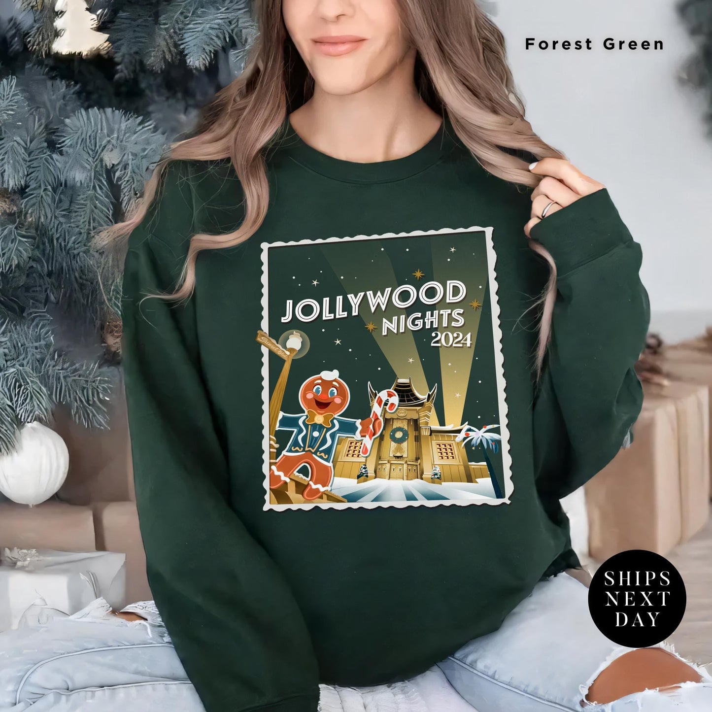 a woman wearing a sweatshirt with a christmas scene on it, Hollywood nights 2024 Christmas Sweatshirt, Hollywood Studios Christmas Shirt, Jollywood Nights Tee, Sweatshirt Hoodie, Family Matching Tee