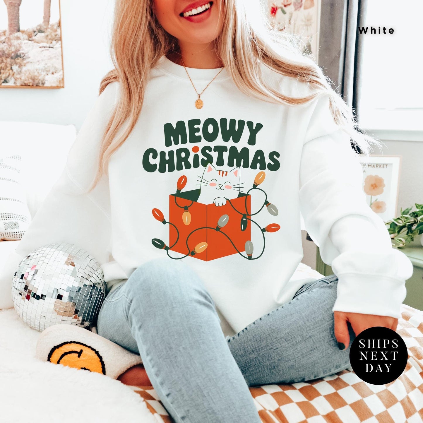a woman sitting on a bed wearing a merry christmas sweatshirt, Meowy Christmas Sweater - Catmas Sweatshirt, Meowy Christmas Sweatshirt, Gift For Cat Mom, Cute Cat Mom Sweatshirts, Holiday Sweatshirts