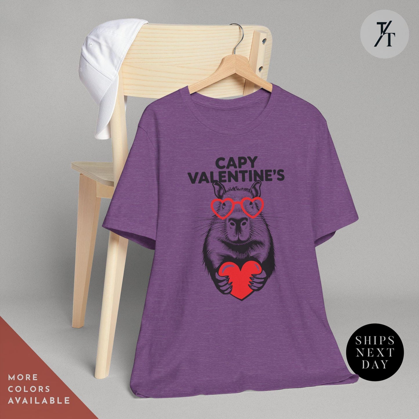 a purple t - shirt with an image of a capybara holding a heart that says Capy Valentines, Capybara Valentines Shirt, Gift For Her, Capybara Lover Gift, Funny Capybaras Shirt, Valentines Day Gifts, Animal Lover Gifts, Capybaras tee