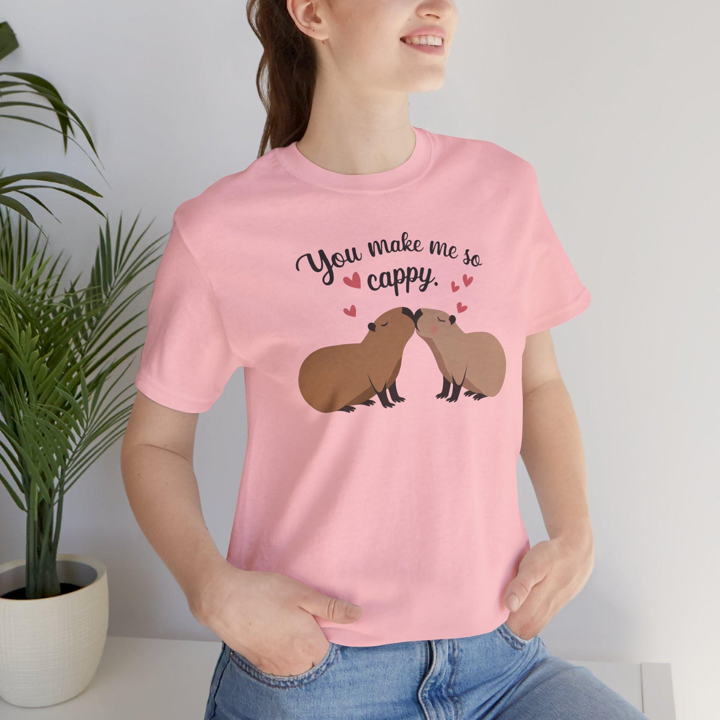 a woman wearing a pink shirt with a couple of capybaras kissing each other with the words you make me so cappy, Capybara Valentines Shirt, Gift For Her, Capybara Lover Gift, Funny Capybaras Shirt, Valentines Day Gifts, Animal Lover Gifts,