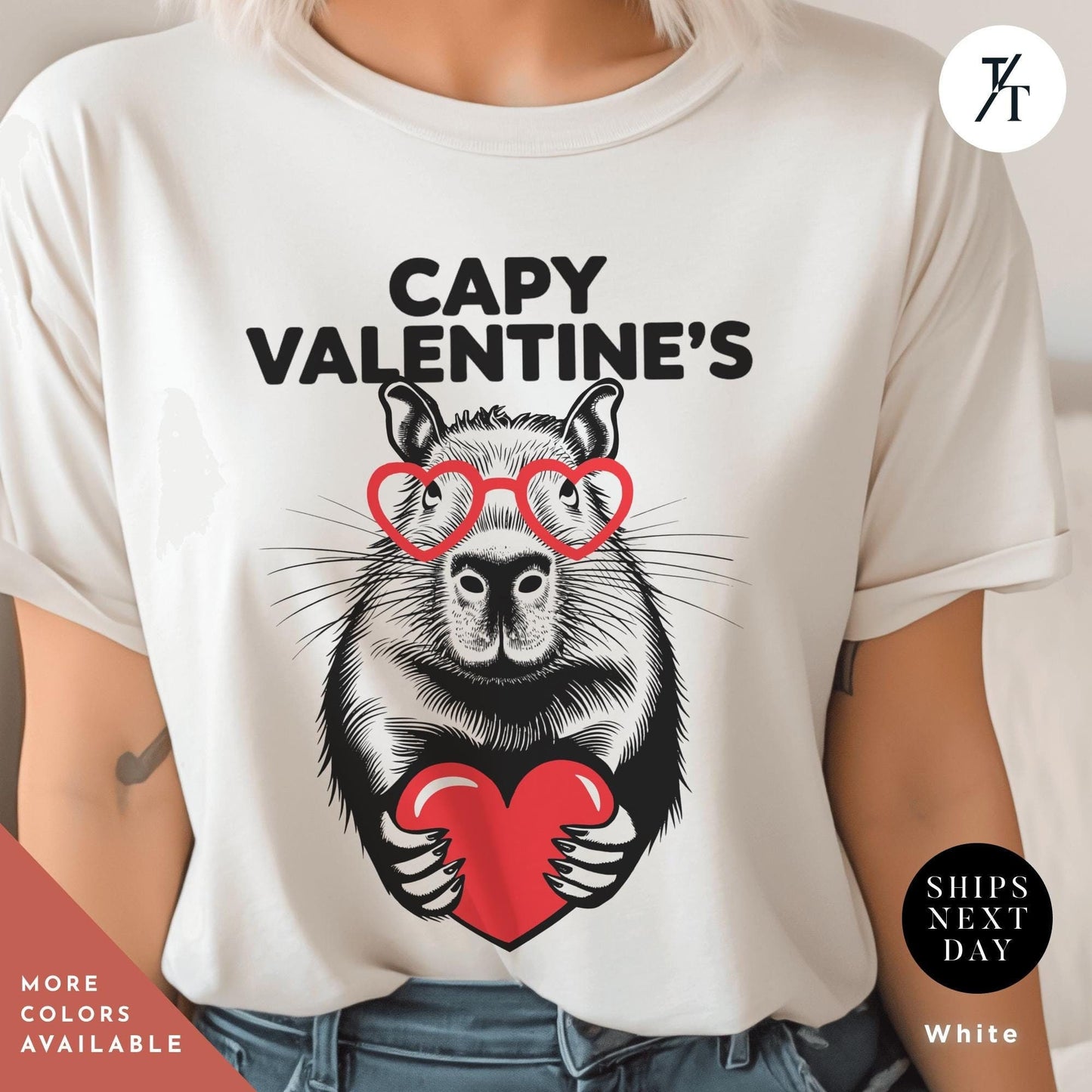 a woman wearing white a t - shirt with an image of a capybara holding a heart that says Capy Valentines, Capybara Valentines Shirt, Gift For Her, Capybara Lover Gift, Funny Capybaras Shirt, Valentines Day Gifts, Animal Lover Gifts, Capybaras tee