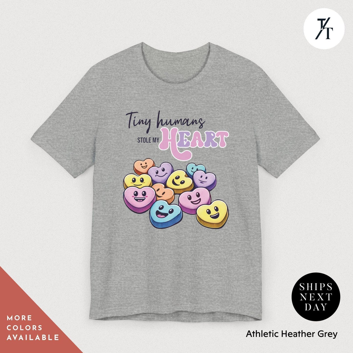 a gray t - shirt with smiley faces on it