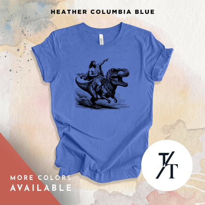 a blue t - shirt with a picture of a man riding a dinosaur
