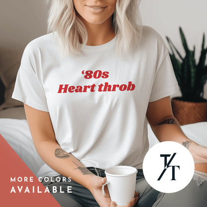a woman sitting on a bed holding a cup of coffee