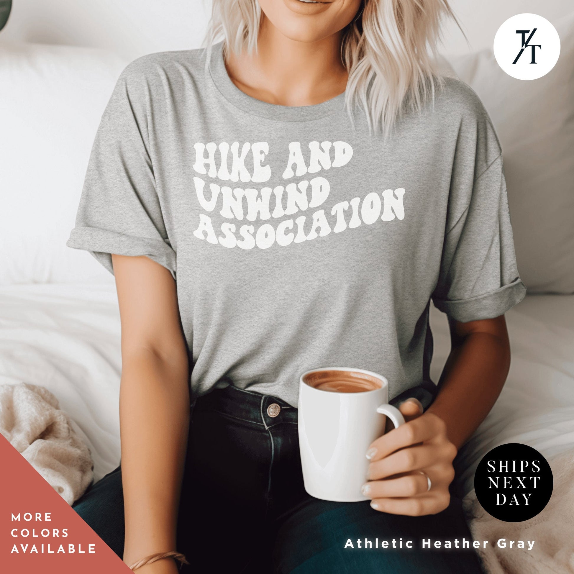a woman sitting on a bed holding a cup of coffee