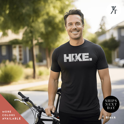 a man standing next to a bike in front of a house