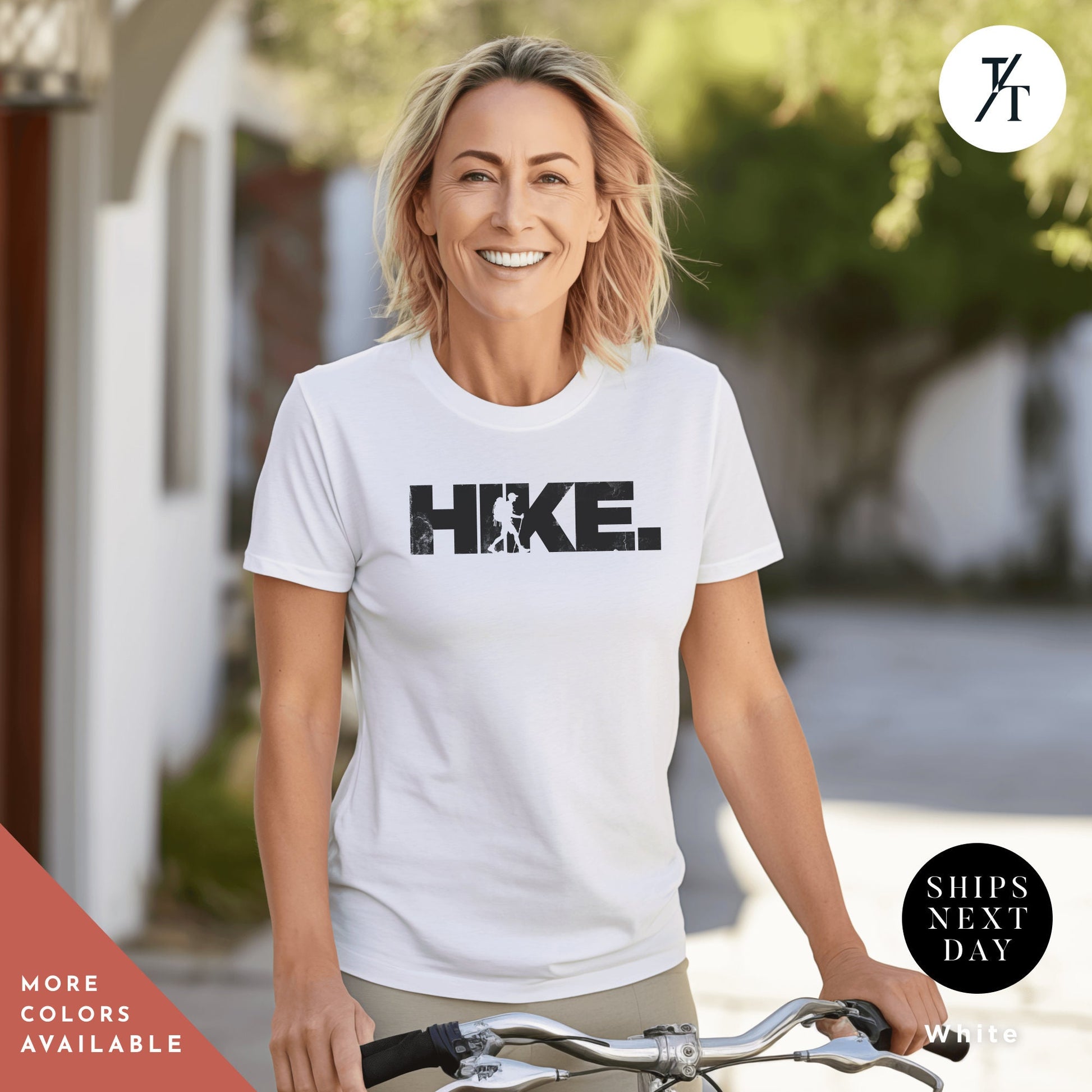 a woman riding a bike wearing a white shirt
