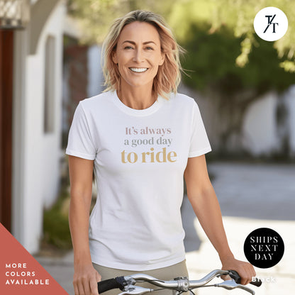 a woman riding a bike wearing a t - shirt that says it&#39;s always