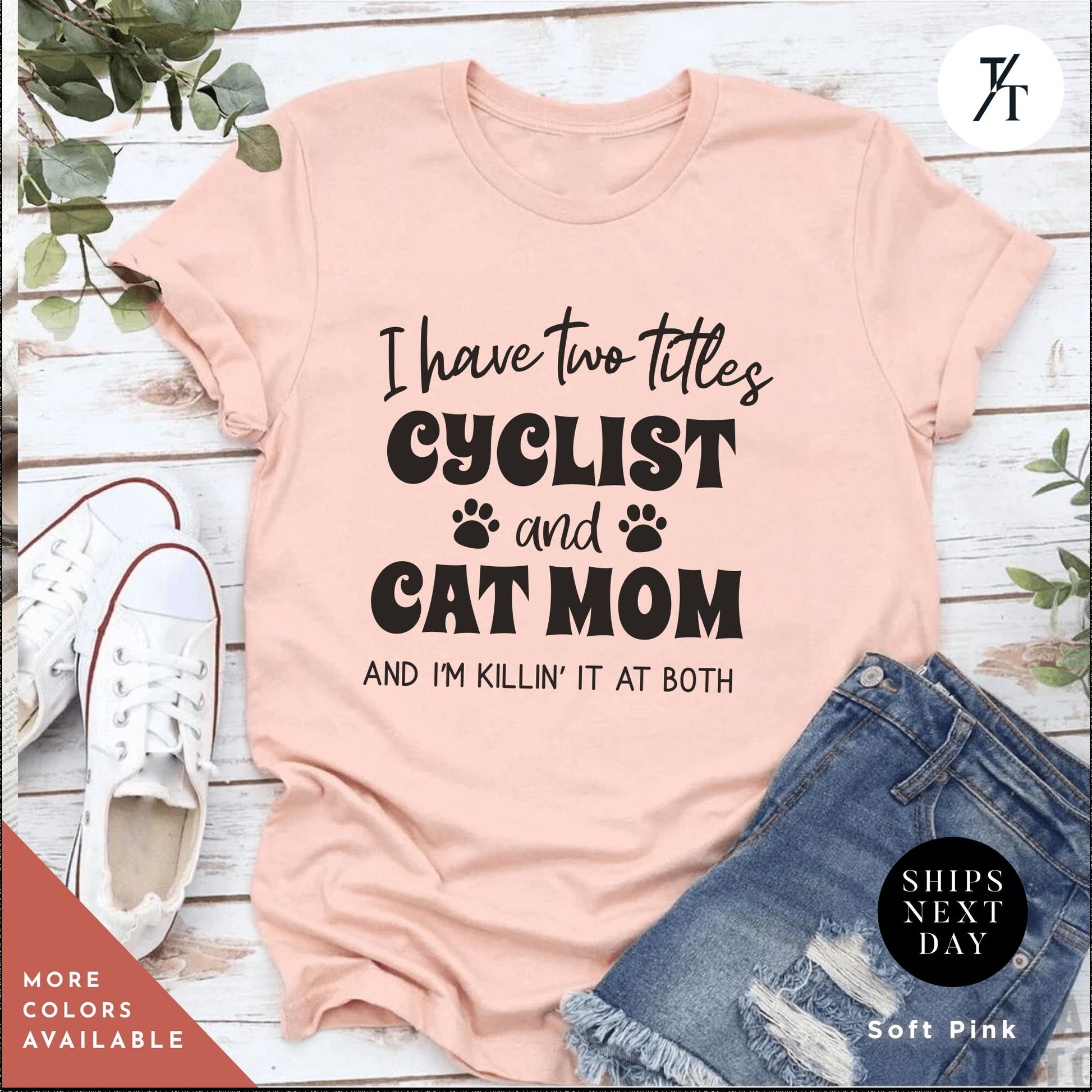 a pink shirt that says i have two titles cyclist and cat mom and i &#39;