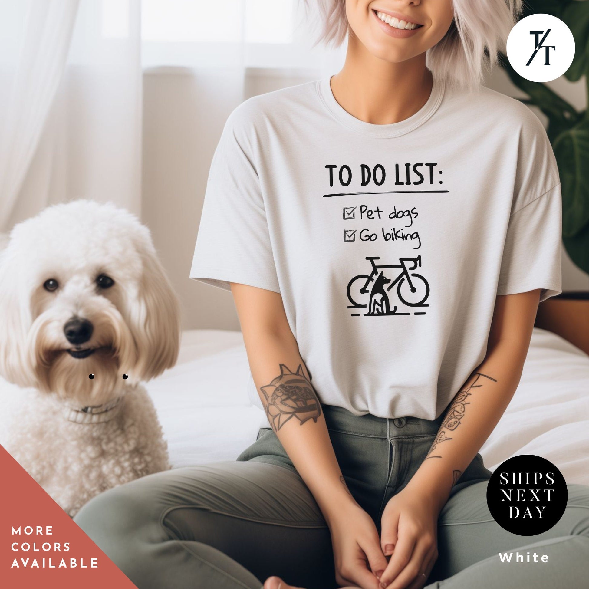 a woman sitting on a bed next to a white dog