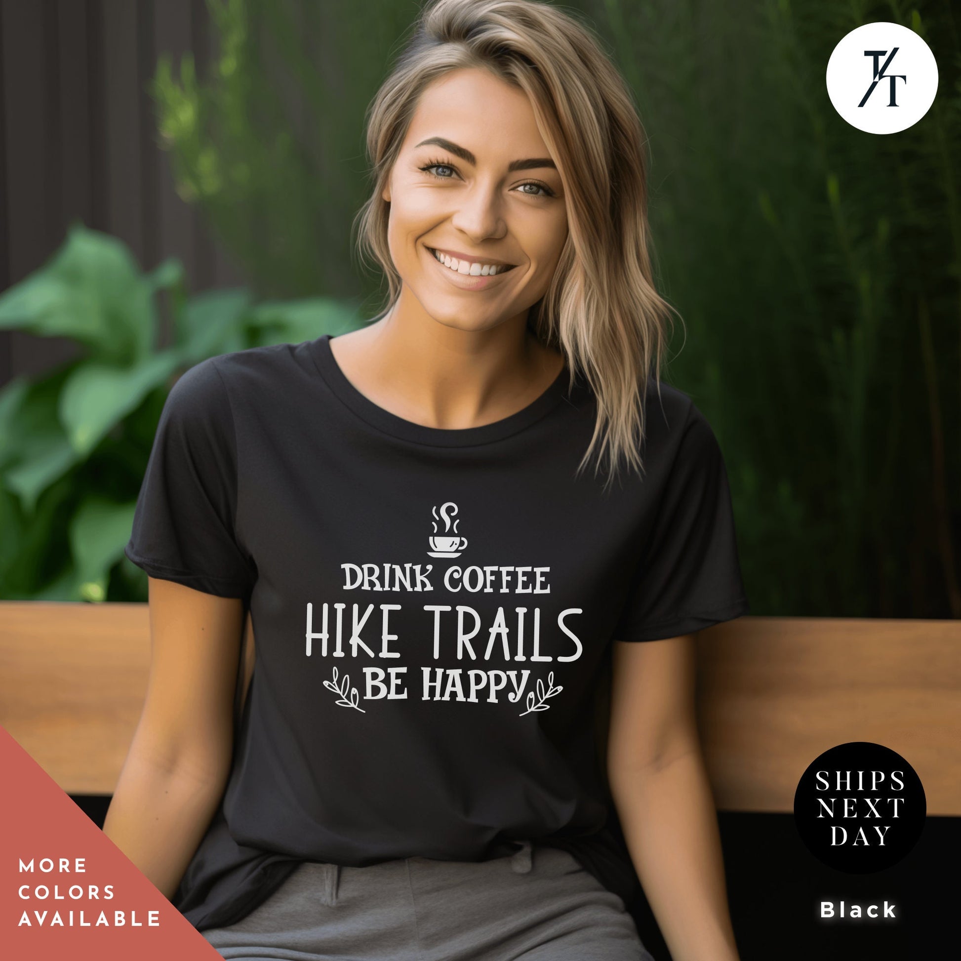 a woman sitting on a bench wearing a t - shirt that says drink coffee hike